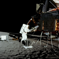 Apollo 12 astronaut Alan Bean unloads the plutonium fuel core