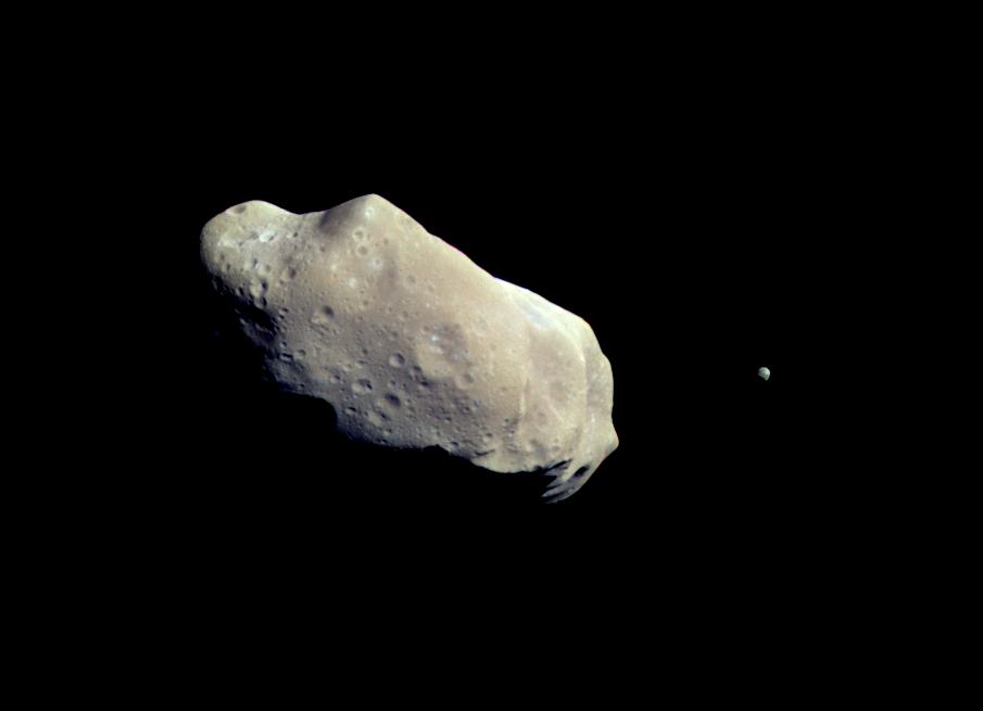 Color picture shows asteroid Ida and its moon, Dactyl. 