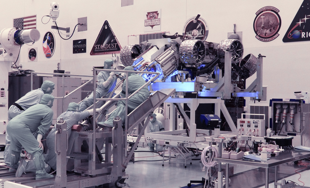 Technicians perform a fit check between the Mars Perseverance rover and its Multi-Mission Radioisotope Thermoelectric Generator