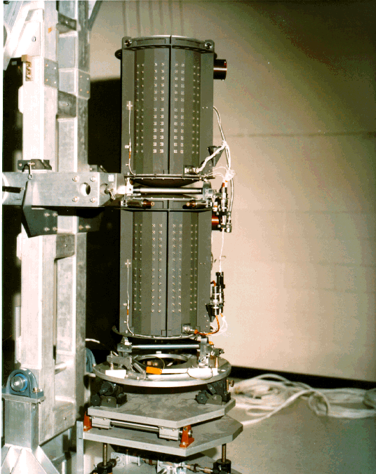 Two Multi-Hundred Watt Radioisotope Thermoelectric Generators being stacked in preparation for integration on a Voyager spacecraft.