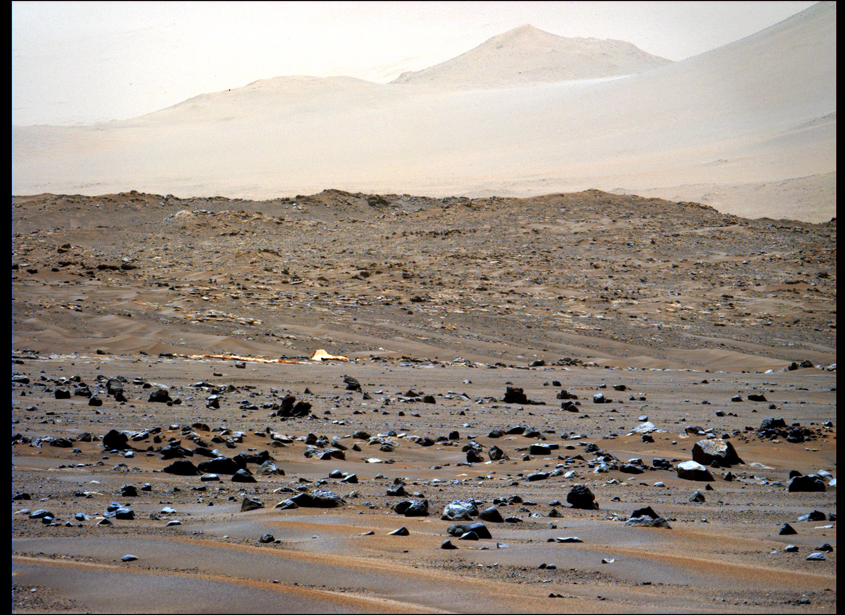 The parachute that helped Perseverance reach Mars lays on the Martian rocks.