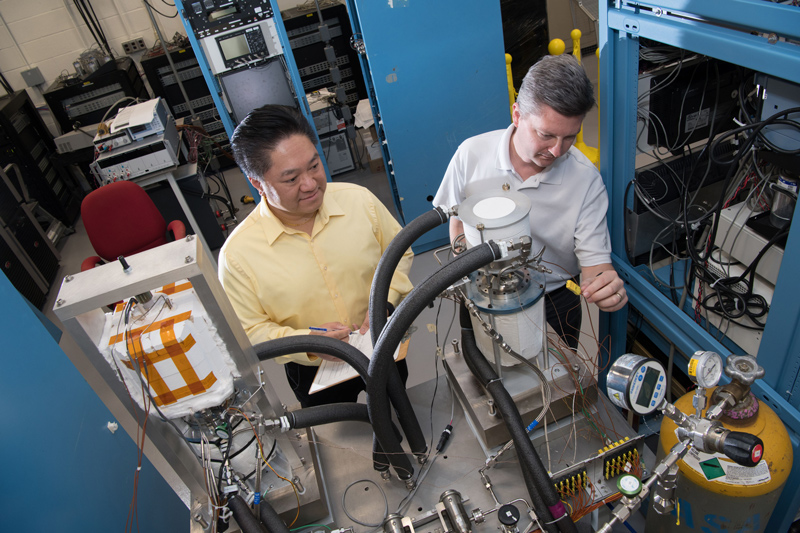 Thermal energy researchers inspect a Stirling power convertor